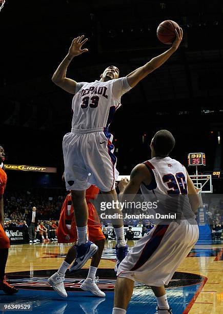 Kris Faber of the DePaul Blue Demons grabs a rebound over teammate Will Walker against the Syracuse Orange at the Allstate Arena on January 30, 2010...