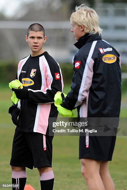 Marco Calderoni new player of Palermo looks at his team mate Simon Kjaer during a training session at Tenente Carmelo Onorato Sports Center on...