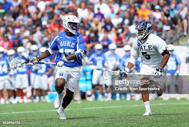 Duke Blue Devils midfielder Nakeie Montgomery pursued by Yale Bulldogs midfielder Tyler Warner during the NCAA Division I Men's Championship match...