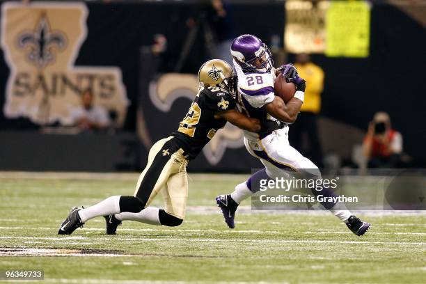 Jabari Greer of the New Orleans Saints attempts to tackle Adrian Peterson of the Minnesota Vikings during the NFC Championship Game at the Louisiana...