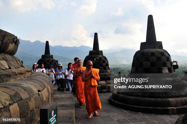 Buddhist monks and devotees conduct prayers at Borobudur temple during Vesak day in Magelang on May 29, 2018. - Buddhist devotees in Indonesia...