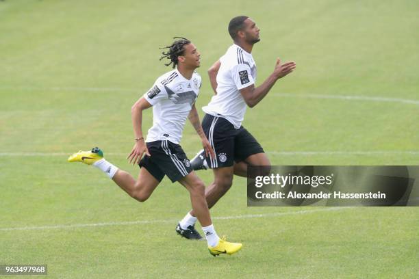 Leroy Sane rusn with team mate Jonathan Tah during a training session of the German national team at Sportanlage Rungg on day seven of the Southern...