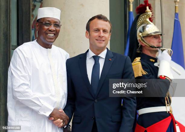 French President Emmanuel Macron welcomes Chad's President Idriss Deby Itno prior to an international conference on Libya at the Elysee Presidential...