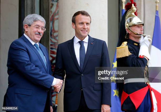 French President Emmanuel Macron welcomes Algerian Prime Minister Ahmed Ouyahia prior to an international conference on Libya at the Elysee...