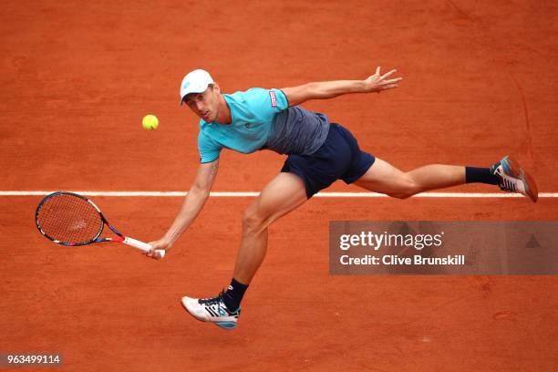 John Millman of Australia plays a forehand during the mens singles first round match against Denis Shapovalov of Canada during day three of the 2018...