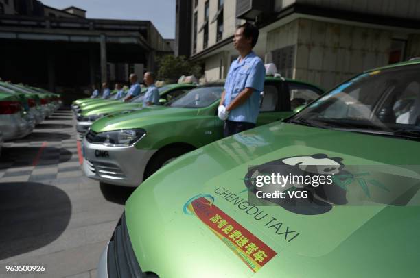 Taxis and drivers line up during a launch ceremony of a public welfare activity held by Chengdu Taxi at a college students pioneer park on May 28,...