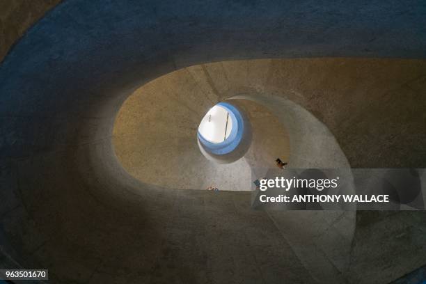 Visitors look down from a set of stairs as they visit Victoria Prison, a former colonial prison and police station colloquially known as Tai Kwun, or...