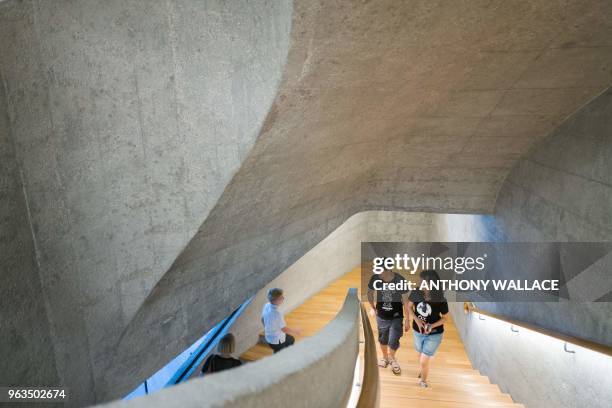 Visitors walk up a set of stairs as they visit Victoria Prison, a former colonial prison and police station colloquially known as Tai Kwun, or "big...