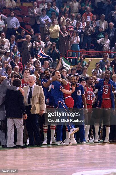 Julius Erving of the Philadelphia 76ers celebrates on the sideline against the Boston Celtics during a game played in 1982 at the Boston Garden in...