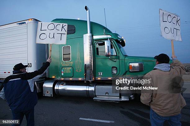 Locked out workers hold signs as a truck enters the front gate of the Rio Tinto Borax mine two days after mine owners locked out about 540 employees...