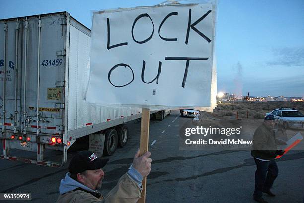 Locked out workers hold signs as a truck enters the front gate of the Rio Tinto Borax mine two days after mine owners locked out about 540 employees...