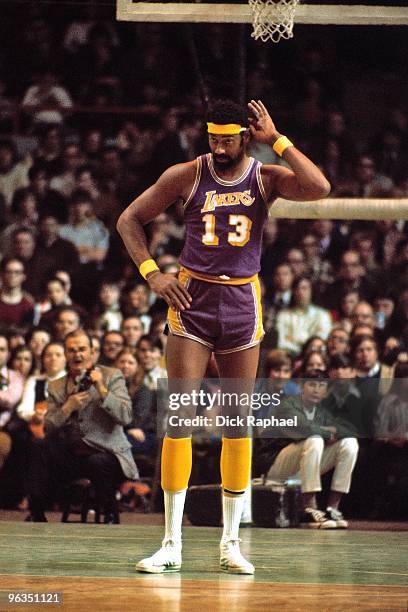 Wilt Chamberlain of the Los Angeles Lakers stands on the court against the Boston Celtics during a game played in 1972 at the Boston Garden in...