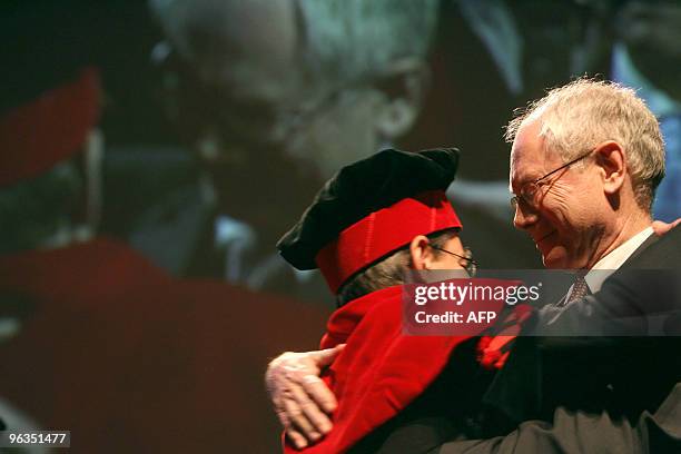 European Union President Herman Van Rompuy hugs Bruno Delvaux, rector of UCL University after Rompuy received a Doctor Honoris Causa at a ceremony at...