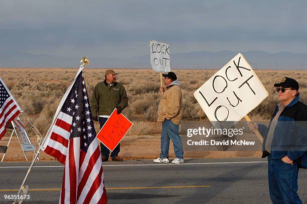Locked out workers carry signs at front gate of the Rio Tinto Borax mine two days after mine owners locked out about 540 employees and called in...