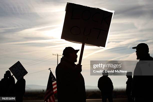 Locked out workers carry signs at front gate of the Rio Tinto Borax mine two days after mine owners locked out about 540 employees and called in...