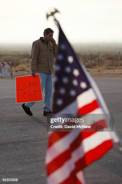 Locked out workers carry signs at front gate of the Rio Tinto Borax mine two days after mine owners locked out about 540 employees and called in...