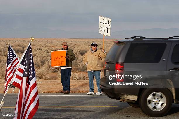 Locked out workers hold signs as a car enters the front gate of the Rio Tinto Borax mine two days after mine owners locked out about 540 employees...