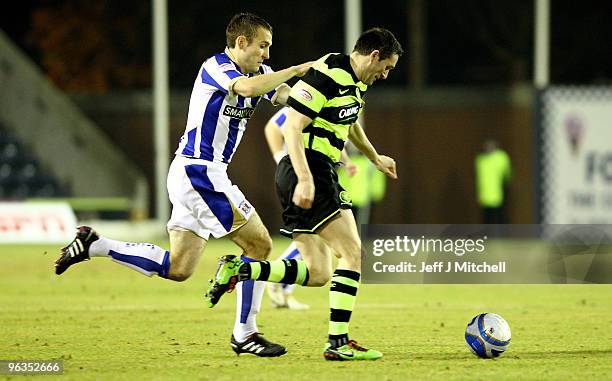 Liam Kelly of Kilmarnock tackles Robbie Keane of Celtic during the Clydesdale Bank Scottish Premier League match between Kilmarnock and Celtic at...