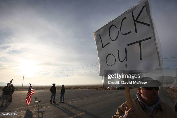 Locked out workers hold signs at the front gate of the Rio Tinto Borax mine two days after mine owners locked out about 540 employees and called in...