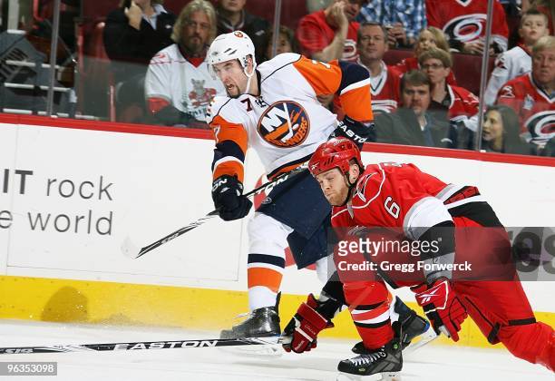 Trent Hunter of the New York Islanders shoots the puck past the defense of Tim Gleason of the Carolina Hurricanes during a NHL game on January 28,...