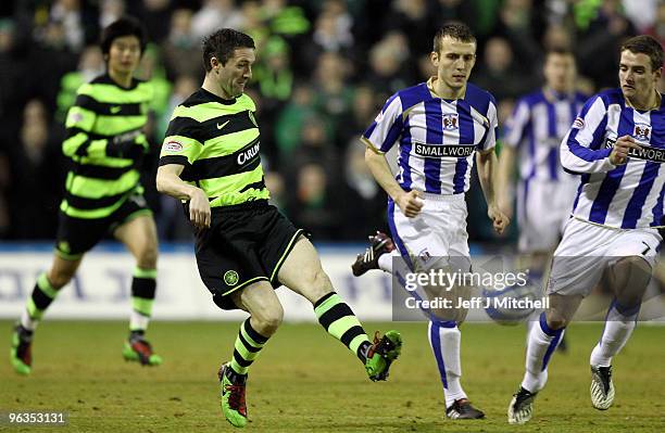 Liam Kelly of Kilmarnock tackles Robbie Keane of Celtic during the Clydesdale Bank Scottish Premier League match between Kilmarnock and Celtic at...
