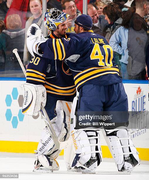 Ryan Miller of the Buffalo Sabres is congratulated by teammate Patrick Lalime after their victory over the Boston Bruins on January 29, 2010 at HSBC...