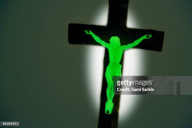 phosphorescent crucifix in the dark - phosphorescence stock pictures, royalty-free photos & images