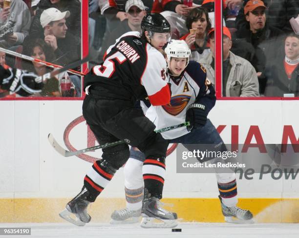 Braydon Coburn of the Philadelphia Flyers checks Colby Armstrong of the Atlanta Thrashers on January 28, 2010 at the Wachovia Center in Philadelphia,...