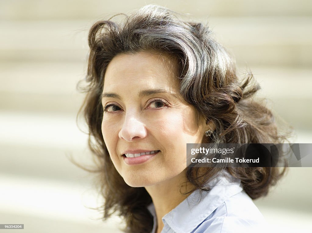 Mature woman smiling outside