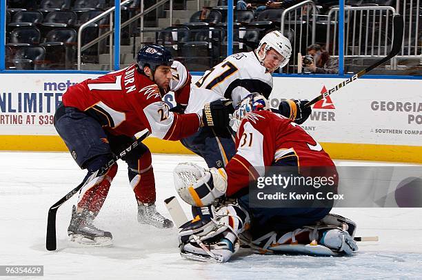 Goaltender Ondrej Pavelec and Chris Thorburn of the Atlanta Thrashers against Tyler Myers of the Buffalo Sabres at Philips Arena on January 14, 2010...