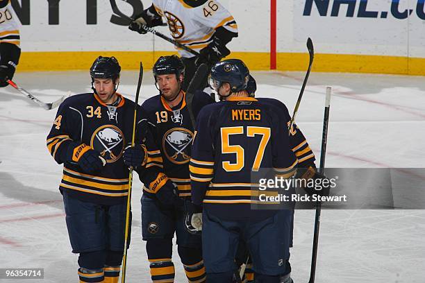 Chris Butler, Tim Connolly, Jason Pominville and Tyler Myers of the Buffalo Sabres look on against the the Boston Bruins during their NHL game at...
