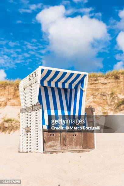 strandkorb (hooded beach chair) on the beach, sylt island. - beach shelter stock-fotos und bilder