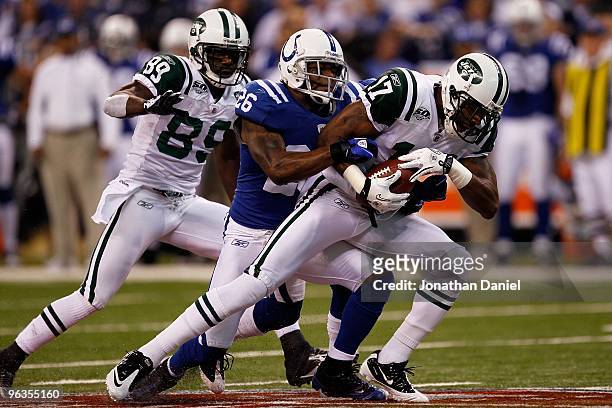 Wide receiver Braylon Edwards of the New York Jets is tackled by Kelvin Hayden of the Indianapolis Colts during the AFC Championship Game at Lucas...