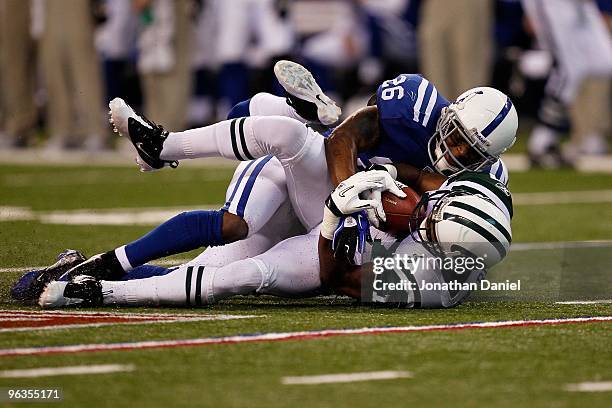 Wide receiver Braylon Edwards of the New York Jets is tackled by Kelvin Hayden of the Indianapolis Colts during the AFC Championship Game at Lucas...