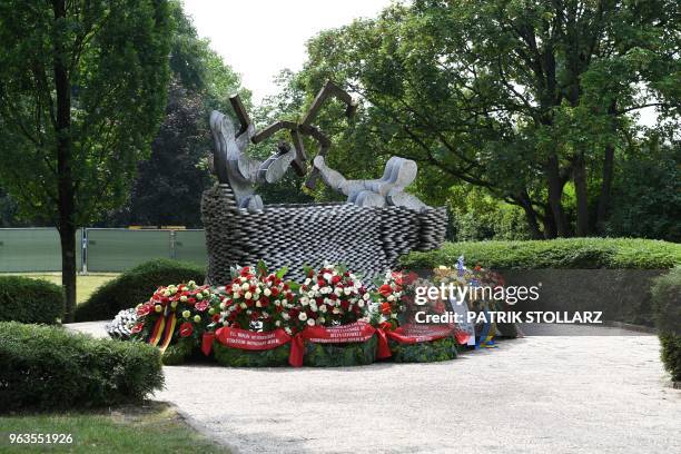 Picture taken on May 29, 2018 in Solingen shows flowers in front of a memorial during a ceremony marking the 25th anniversary of an arson attack that...