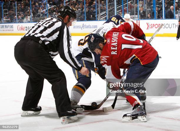 Linesman Thor Nelson drops the puck during a face off between Tim Connolly of the Buffalo Sabres and Marty Reasoner of the Atlanta Thrashers at...