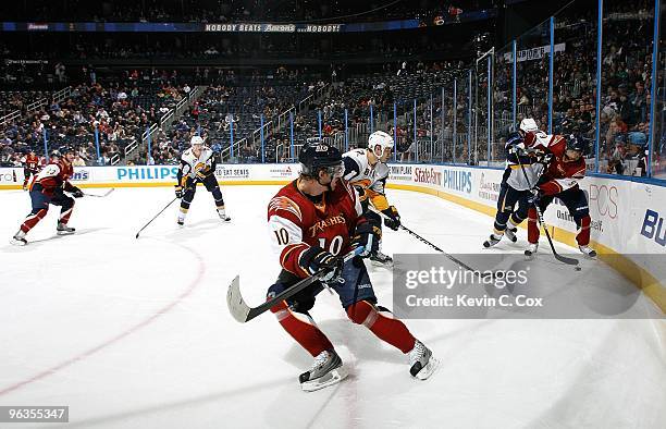 Bryan Little of the Atlanta Thrashers looks on as Evander Kane battles for the puck against the Buffalo Sabres at Philips Arena on January 14, 2010...