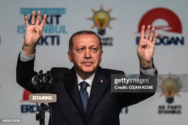 Turkish President Recep Tayyip Erdogan flashes four finger sign on May 29, 2018 in Istanbul during an electoral meeting presenting candidates for the...