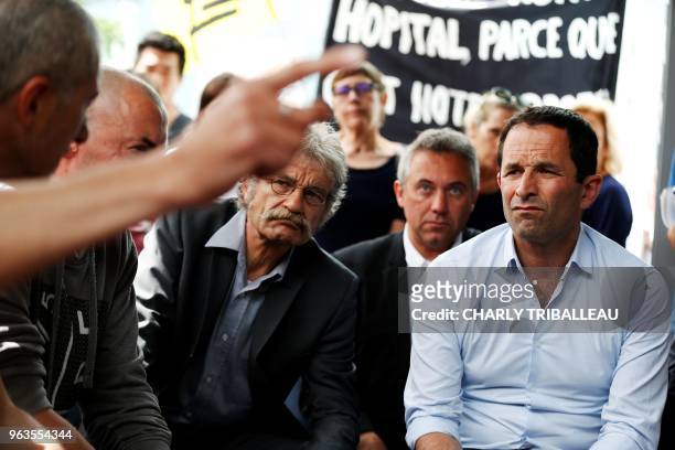 Benoit Hamon, leader of the left-wing political movement Generations , listens during a meeting with seven employees on hunger strike at the Centre...