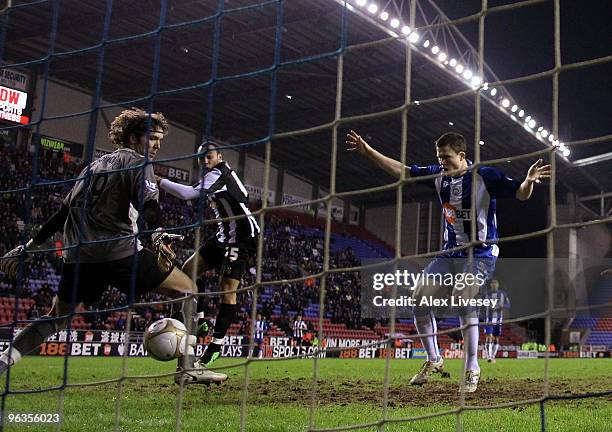 Gary Caldwell of Wigan Athletic puts the ball past Vladimir Stojkovic to score an own goal during the FA Cup sponsored by E.ON 4th Round Replay match...