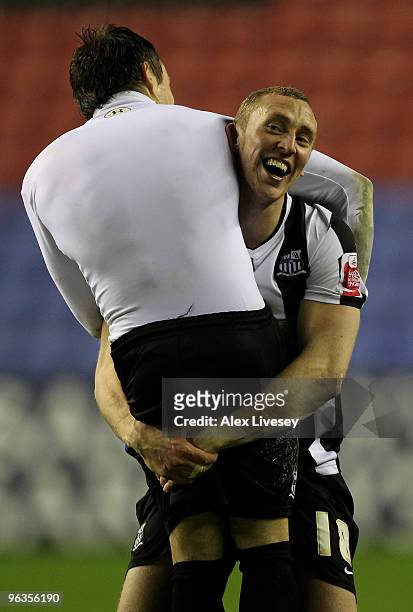 Stephen Hunt of Notts County celebrates with teammate Ben Davies after their victory over Wigan Athletic in the FA Cup sponsored by E.ON 4th Round...