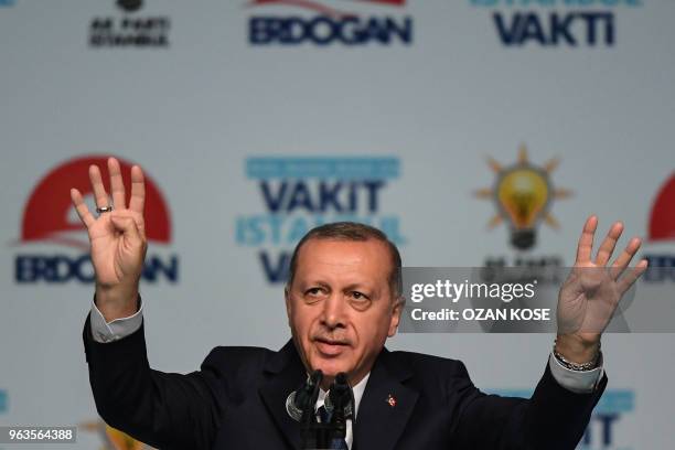 Turkish President Recep Tayyip Erdogan flashes four finger sign on May 29, 2018 in Istanbul during an electoral meeting presenting candidates for the...