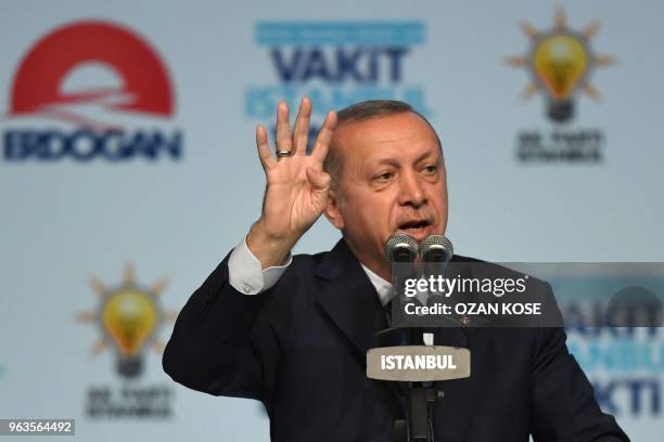 Turkish President Recep Tayyip Erdogan flashes four finger sign on May 29, 2018 in Istanbul during an electoral meeting presenting candidates for the...