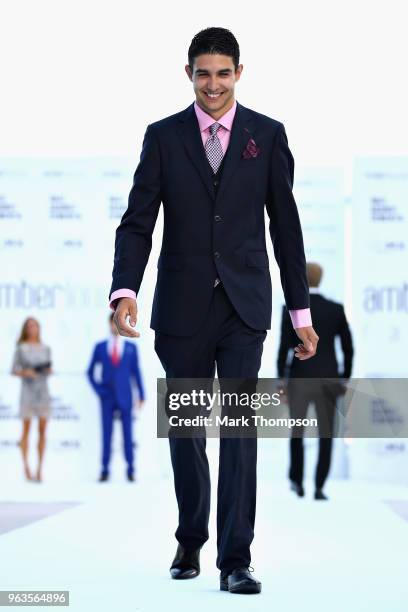Esteban Ocon of France and Force India walks the catwalk at the Amber Lounge Fashion show during previews ahead of the Monaco Formula One Grand Prix...