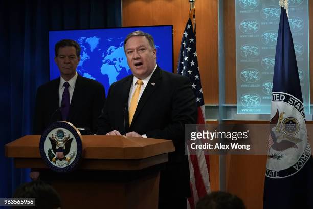 Secretary of State Mike Pompeo speaks as State Department Ambassador at Large for International Religious Freedom Sam Brownback listens during a...