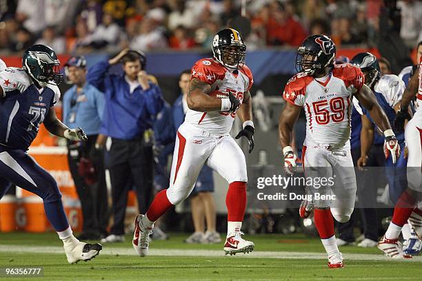 DeMeco Ryans of the Houston Texans covers LaMarr Woodley of the Pittsburgh Steelers after making an interception during the 2010 AFC-NFC Pro Bowl at...