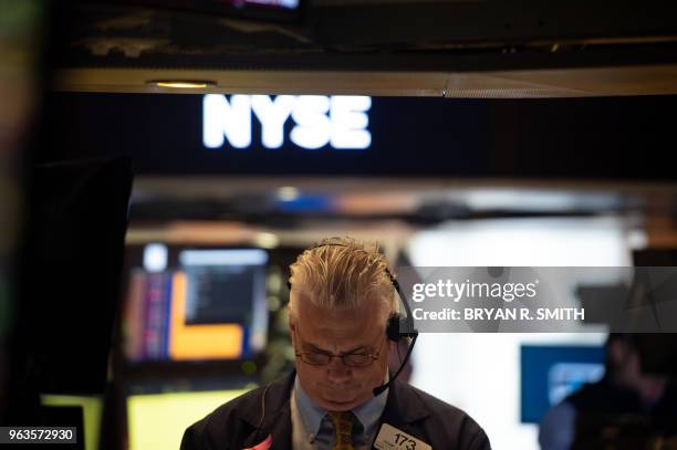 Traders work on the floor of the Dow Industrial Average at the New York Stock Exchange on May 29, 2018 in New York. - US stocks retreated early...