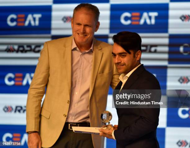 Former Australian cricketer Tom Moody presents T20 Bowler of the Year Award to Afghan cricketer Rashid Khan during CEAT Cricket Rating Awards...