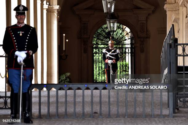 Corazzieri, of the Italian military Presidential honour guards, stand guard at the Quirinal palace as Carlo Cottarelli, 64-years-old, an economist...
