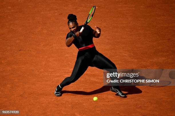 Serena Williams of the US plays a forehand return to Czech Republic's Kristyna Pliskova during their women's singles first round match on day three...